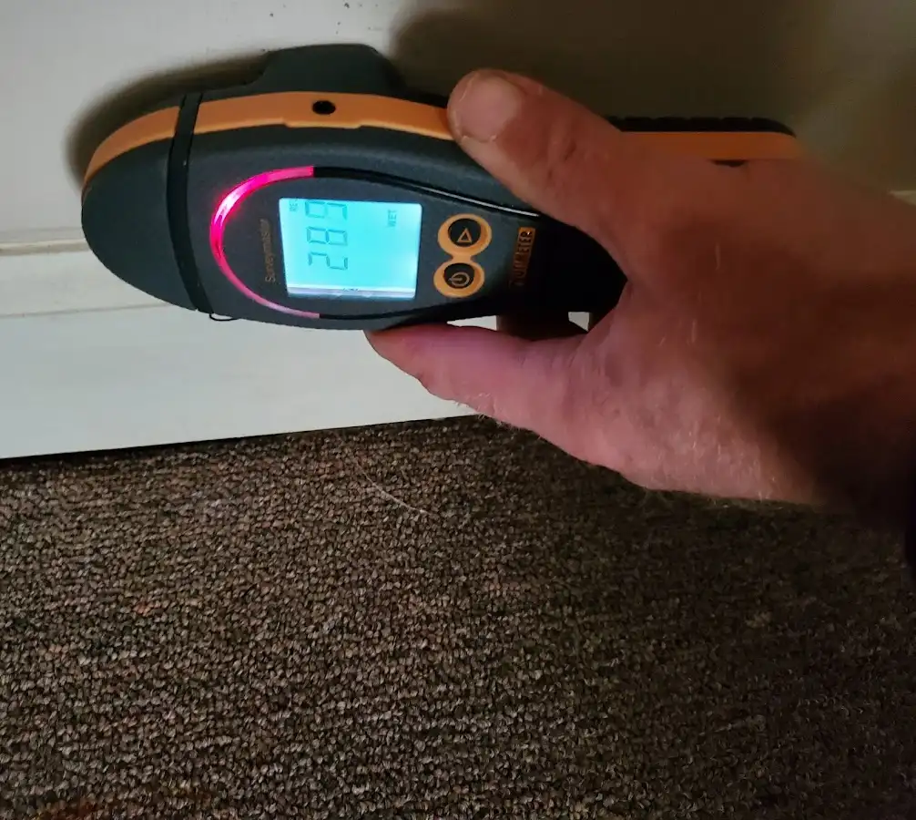 Moisture detection at baseboard during Storm Damage Restoration in Westampton